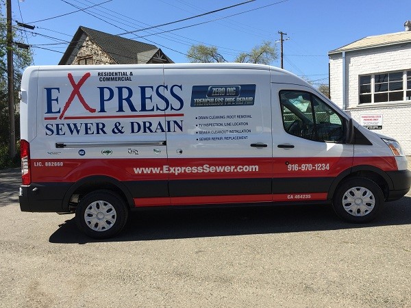 Photo of a van parked with Express Sewer and Drain vehicle graphics.