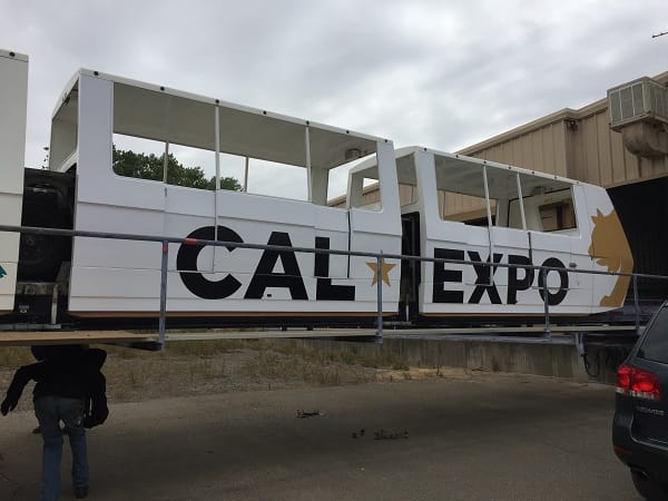 Photo of the Cal Expo light rail with new Cal Expo graphics in black and gold.