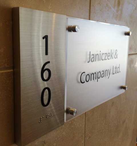 ADA compliant interior sign for Janiczek & Company Ltd. with braille.