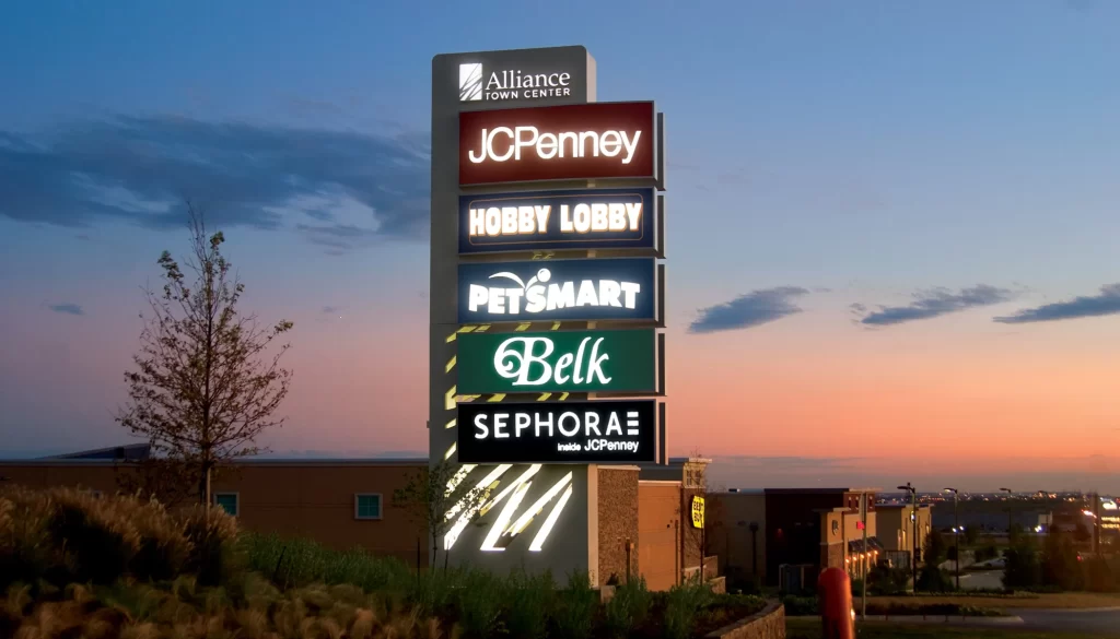 Large exterior electrical monument sign listing each business individually.